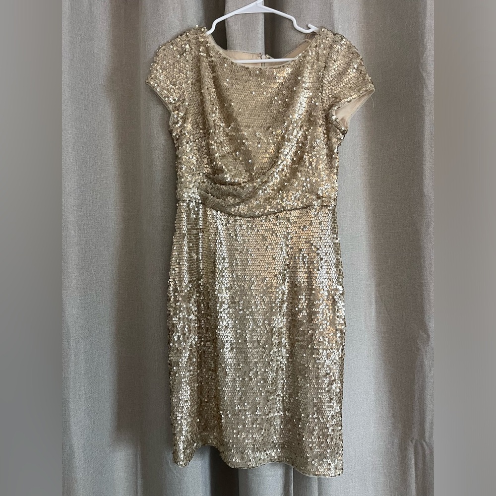 Gold sequin dress. Has a design in the front. In good condition!